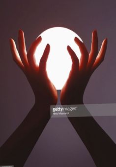 two hands reaching out towards the sun stock photo