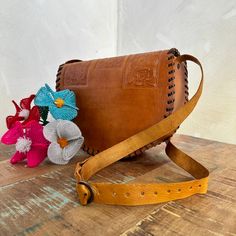 MADE IN MEXICO By: Mexican Artisans For: Women Color: tan brown Dimensions: 10.5 x 8 x 3.5 Details: 100% Authentic Leather Style: Crossbody | Shoulder Bag Embossed Design Adjustable & Non-Removable Strap: 22" Drop Clasp button closure Contact us for more detailsPLEASE READ BEFORE PURCHASE: The picture is an ACCURATE REPRESENTATION.Colors in the pictures may vary a little by effects of light. Each product is handmade from Mexico causing differentiation and minor imperfections in each piece making Brown Satchel Flap Bag With Adjustable Strap, Brown Flap Satchel Bag With Adjustable Strap, Dark Tan Satchel With Adjustable Strap, Hand Tooled Crossbody Satchel For Travel, Vintage Brown Satchel With Mobile Phone Bag, Brown Rectangular Flap Bag For Everyday, Dark Tan Rectangular Bag With Adjustable Strap, Rectangular Dark Tan Bag With Adjustable Strap, Camel Crossbody Satchel For Daily Use