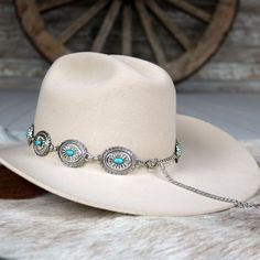 Elevate your hat with our Silver Concho Chain Hat Band, featuring striking turquoise-colored stones. The silver-tone conchos measure 1.5 inches by 1.25 inches and fit most adult hat sizes. Adjustable for the perfect fit. Hat not included.     Color: Silver  Concho Dimensions: 1.5 inches x 1.25 inches  Fits Most Adult Hat Sizes  Adjustable  *Hat not included*  CA Residents: Prop 65 Warning ↗️ Southwestern Turquoise Hat Bands For Country Events, Silver Hat With Adjustable Fit And Short Brim, Western Silver Hat With Short Brim, Adjustable Silver Hat Bands For Festivals, Southwestern Style Turquoise Hat For Ranch, Southwestern Turquoise Hat Band For Ranch, Western Silver Hat Bands For Festivals, Silver Adjustable Hat For Rodeo, Silver Adjustable Hat With Short Brim