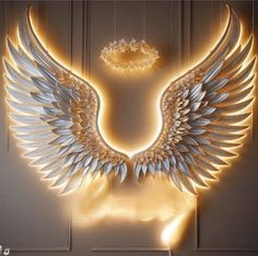 an illuminated angel wing sculpture in front of a door