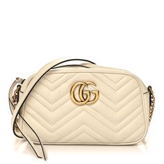 This is an authentic GUCCI Calfskin Matelasse Small GG Marmont Chain Shoulder Bag in White. This stylish shoulder bag is made of soft calfskin leather in off white. This shoulder bag features an antiqued gold chain and leather shoulder strap, and a Gucci GG logo on the front. The top zipper opens to a beige microfiber interior with a patch pocket. Gucci Soft Leather Crossbody Bag, Classic Gucci Soft Leather Bag, Elegant Gucci Soft Leather Bags, Gucci Luxury Soft Leather Shoulder Bag, Luxury Gucci Shoulder Bag In Soft Leather, Luxury Gucci Soft Leather Shoulder Bag, Chic Gucci Bag In Soft Leather, Chic Gucci Soft Leather Bag, Gucci Soft Leather Crossbody Shoulder Bag