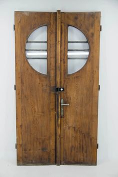 an old wooden door with two glass panels on the front and side doors are made out of wood