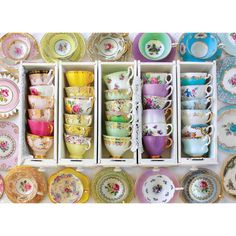 an assortment of tea cups and saucers