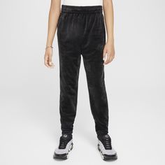 Velvety soft and oh-so cozy, these joggers are our go-to for chilly days. A supersoft and slightly fuzzy jersey knit keeps things comfy while a tapered leg and ribbed cuffs set your sneakers up to shine. Girls Joggers, Polyester Spandex, Nike Sportswear, Knit Jersey, Lifestyle, Nike, Sneakers, Black