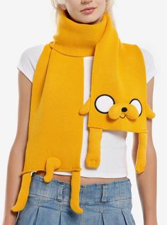 a woman wearing a yellow scarf with a cartoon character on it's face and eyes