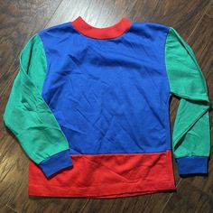 Vintage Healthtex color block long sleeve shirt. Red, Blue and green. In excellent condition. Size 6. Made in USA. Green Tops With Contrast Color For Fall, Green Contrast Color Tops For Fall, Winter Long Sleeve Patchwork Shirt, Green Winter Tops With Contrast Color, Winter Green Tops With Contrast Color, Green Contrast Color Tops For Winter, Green Color Block Long Sleeve Top, Multicolor Long Sleeve Shirt With Contrast Color, Casual Long Sleeve Shirt With Contrast Color