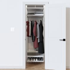 an open closet with clothes on hangers and shoes in the bottom drawer, next to a white door