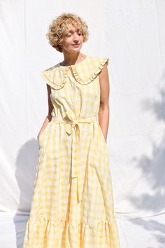 Maxi dress made in a yellow seersucker check print fabric. Loose and extremely comfortable fit, can be worn with or without a matching fabric tie belt. Elegant and feminine look. • Handmade in our studio • A-line silhouette • Sleeveless bodice • Matching fabric tie belt • Puritan collar with ruffled details • Button loop closure on the back • Hidden side seam pockets • Available from XXS to XXL size or can be made in a custom size Sleeveless Seersucker Dresses For Daywear, Sleeveless Gingham Seersucker Dress, Vintage Sleeveless Plaid Cotton Dress, Sleeveless Cotton Plaid Dress With Ruffles, Yellow Cotton Dress For Picnic, Puritan Collar, Check Dress, Sleeveless Dress Summer, Dress Silhouette