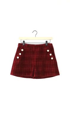 These shorts are made from a plaid red fabric with vintage gold buttons that add an eye-catching detail to the design. The shorts are designed with two front pockets for conveniently storing your essentials. Complete the look with the matching Tricia Cropped Blazer or mix and match with other closet favorites. Shorts Plaid Front pockets Inseam: 3 1/4" Front rise: 11 1/2" Back rise: 16" Waist: 14" Self : 100% Polyester Hand wash cold. Dry flat. Low iron, or dry clean Model is wearing a size small Comfortable Pants, Luxury Women Fashion, Cropped Blazer, Plaid Fabric, Low Iron, Girl Falling, Model Pictures, Red Fabric, Merlot