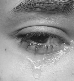 a man's eye with water drops coming out of it