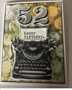 a card with an old fashioned typewriter on it, and the words happy birthday written in