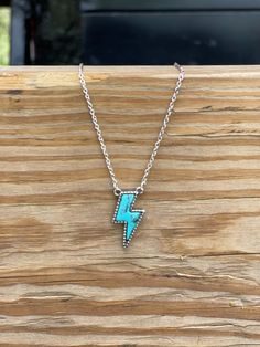 Looking to add a pop of turquoise to your jewelry collection? This Lightning Bolt Stone Necklace can add a bit of flash to any western inspired outfit! It features a silver chain with a turquoise stone bordered with a silver accent. Light up any look with this bolt of color. Faux silver and turquoise Cheap Turquoise Summer Jewelry, Cheap Turquoise Necklace, Cheap Turquoise Necklaces For Festivals, Cheap Turquoise Necklace For Festivals, Lightning Jewelry, Punchy Jewelry, Western Jewerly, Western Fashion Jewelry, Southern Jewelry