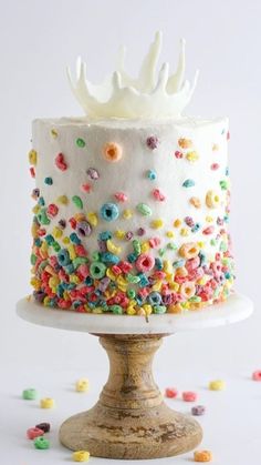 a white cake with sprinkles and a crown on top