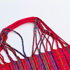 This unique bag is beautifully made on a waist loom, (Telar de Cintura) by artisans from Chiapas México. Each bag is individually handwoven with a unique colors and designs . There is not other like it! Use this reusable and eco-friendly, 100% cotton loom tote bag as a shopping bag for farmer's markets . Dress it down with a t-shirt and jeans or shorts! or to add a boho vibe to any outfit. Details: Tote measurements: 14 x 16.5 inch Handle drop: 10" Material: 100% Cotton Color: hot pink with colo Handmade Multicolor Beach Bag For Festivals, Red Handwoven Beach Bag For Shopping, Red Handwoven Beach Bag For Market, Multicolor Woven Beach Bag For Festival, Eco-friendly Multicolor Handwoven Beach Bag, Bohemian Woven Cotton Beach Bag, Handwoven Multicolor Beach Bag For Festival, Multicolor Handwoven Beach Bag For Festival, Multicolor Weaving Work Bags For Beach