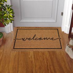 Welcome guests with a simple style, "Welcome" printed coir doormat. Coir fibers used to make this mat are extracted from Coconut husks, which are otherwise wasted. Each mat uses fiber from about 16 coconuts. The fiber is converted to yarn and then used to make these versatile doormats. After making the plain mat, the design is hand-stenciled by craftsmen, one layer at a time. The naturally resilient Coir mat scrapes mud, sand, water and dirt off shoes and the vinyl backing is slip resistant and durable. This is a highly functional doormat. Style Selections 1-1/2-ft x 2-1/2-ft Natural Coir/Vinyl Rectangular Indoor or Outdoor Decorative Door Mat in Black | WG-1830-CURSWEL Cute Door Mat, Last Name Door Mat, Hand Painted Door Mats, Front Door Matt, Cute Door Mats, Doormat Ideas, Outdoor Welcome Mat, Welcome Door Mat, Hand Stencil