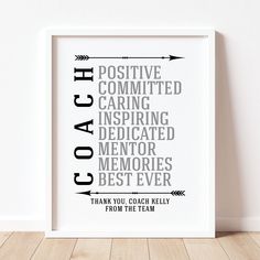 a white framed poster with the words coach written in black on it, against a white wall