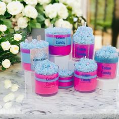 there are many candles that have been decorated with blue and pink frosting on them