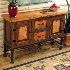 a large wooden cabinet with drawers in front of a window and potted plant on top