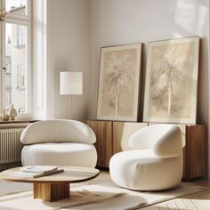 a living room with two chairs and a coffee table in front of a large window