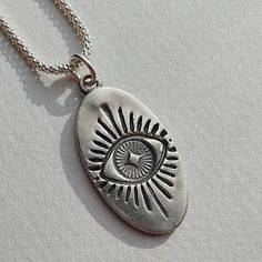 "This silver necklace features the mythical Evil Eye pendant and a sterling silver chain. It can make a great gift for a loved one or be a protection gift for yourself. The Evil Eye Symbol is known to guard against misfortune and negative energy. It brings good luck and protects you from envy and bad thoughts. Layer up this pendant with other designs or chains from EgoElements to create unique looks💫 Materials 999 fine silver pendant 925 sterling silver chain (if ordered with a chain) Size (app Silver Sterling Oval Charm Necklaces, Silver Sterling Silver Charm Necklace With Oval Pendant, Silver Sterling Silver Oval Pendant Charm Necklaces, Silver Oval Pendant Charm Necklace In Sterling Silver, Oval Silver Sterling Silver Charm Necklaces, Silver Oval Sterling Silver Charm Necklace, Nickel-free Sterling Silver Oval Pendant Necklace, Spiritual Silver Charm Necklace As Gift, Spiritual Engraved Charm Necklace For Good Luck