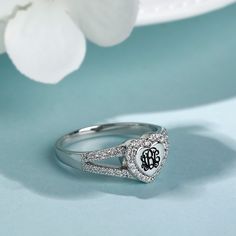 Monogram rings are the perfect option for fashionistas everywhere with a taste for elegance. This monogram ring showcases three elegant, intertwined initials wrapped in halo frames of round stones. Additional side stones adorn the split shank to complete this elegant look. This custom monogrammed ring is a beautiful accoutrement to any monogram jewelry collection.Material: Plating Color: Silver Monogram Rings, Heart Monogram, Monogram Ring, Monogram Jewelry, Personalized Rings, Split Shank, Custom Monogram, Quality Jewelry, Sterling Silver Ring