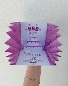 a hand holding up a card that says hbd felices 20 on it