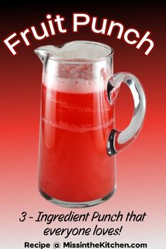 a pitcher filled with red liquid sitting on top of a table next to a sign that says, fruit punch