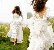 a woman in a white dress is walking through the grass with her back to the camera