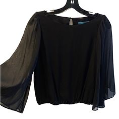 Stunning 100% Silk Alice + Olivia Blouse With Elegant Sheer Sleeves, Key Hole Closure In Back. Very Flattering Fit. Never Worn And Very Well Cared For - There Are No Pulls On The Fabric, Looks Brand New! In Excellent, Like New Condition, Size Xs Chic Long Sleeve Cocktail Top, Elegant Black Blouse With Sheer Sleeves, Black Silk Top For Spring, Black Silk Tops For Spring, Fitted Evening Tops With Blouson Sleeves, Fitted Tops With Blouson Sleeves For Evening, Fitted Top With Blouson Sleeves For Night Out, Fitted Blouse With Blouson Sleeves For Evening, Black Office Top With Sheer Sleeves