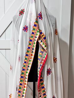 Gorgeous georgette dupatta with mirror and thread work Experience the elegant look and intricate design of our Navaratri Dupatta in white. The perfect combination of georgette fabric with mirror and thread work creates a stunning and luxurious accessory for your traditional outfits. Elevate your style with our high-quality product that adds a touch of sophistication to your Navaratri celebrations. White Bohemian Saree With Traditional Drape, White Choli With Sheer Dupatta, Bohemian White Saree For Traditional Ceremonies, White Georgette Embroidered Fabric For Navratri, Navratri White Embroidered Georgette Fabric, White Embroidered Georgette Fabric For Navratri, White Unstitched Embroidered Fabric For Navratri, Navratri White Unstitched Embroidered Fabric, White Resham Embroidered Fabric For Navratri