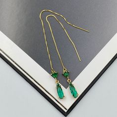 Elegant thread earrings featuring radiant emerald green crystals, intricately set to capture light from every angle. These slender drop earrings seamlessly blend classic charm with contemporary design, making them a perfect accessory for both everyday wear and special occasions. Their shimmering hue adds a touch of luxury, effortlessly elevating any ensemble. Measurements: The total length from the top of the hook to bottom - 4.13 inches (105 mm) approximately. Connector crystal: 5 mm x 5 mm Crystals: 12 mm x 4 mm These earrings would be a PERFECT GIFT for you and your family and friends!  Click here to see more Modern Everyday Earrings: https://www.etsy.com/shop/GrigorevaK?ref=seller-platform-mcnav§ion_id=27174357 Thank you for your visit! Emerald Green Thread Earrings, Green Teardrop Ear Green Pierced Drop Earrings, Green Drop Earrings, Pierced, Green Crystal Earrings For Pierced Ears, Elegant Green Crystal Earrings For Pierced Ears, Green Cubic Zirconia Drop Earrings, Green Crystal Earrings For May Birthstone Anniversary, Green Cubic Zirconia Earrings For May Birthstone, Elegant Green Long Drop Earrings, Elegant Green Teardrop Earring (single)