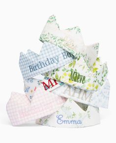 a pile of personalized baby bibs on top of each other in different colors