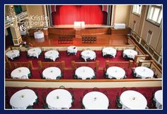 an overhead view of tables and chairs in a large room with red carpeted flooring