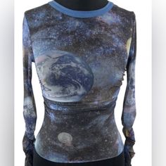 This Women's Urban Outfitters Blue Galaxy Mesh Top Is Perfect For A Night Out On The Town. It Is Made Of A Soft And Stretchy Mesh Fabric That Is Comfortable To Wear. The Top Features A Unique Galaxy Print With Stars, Planets, And Moons. It Has A Slim Fit And Is Cropped At The Waist. The Sleeves Are Long And Have A Ruffled Hem. The Top Is In Excellent Condition And Has Only Been Worn Once. Blue Y2k Crop Top, Fitted Blue Crop Top With Graphic Print, Urban Outfitters Blue Graphic Print Tops, Urban Outfitters Blue Tops With Graphic Print, Fitted Blue Y2k Tops, Fitted Blue Y2k Style Tops, Fitted Y2k Blue Tops, Trendy Fitted Blue Tops, Fitted Trendy Crop Top By Urban Outfitters