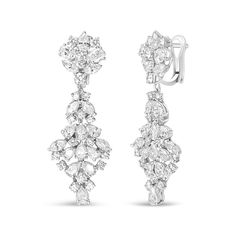 Brimming with the vivacious sparkle of natural, white diamonds, these dazzling drop earrings for her feature marquise, oval, pear, and round shaped diamonds in a prong-setting and arranged in a cluster design. These geometric-inspired cluster earrings form a decadent display of shimmering beauty and are styled for length to capture an eye-catching dangle that catches the light as you move. Fashioned in genuine 18k white gold, the total diamond weight is 9 1/2 carat and the diamonds are of an approximate F-G color and VS1-VS2 clarity. The earrings secure with clip on backs for sizzling nighttime styling. Cluster Design, Geometric Inspiration, Cluster Earrings, American Jewelry, Diamond Cluster, 2 Carat, White Diamonds, White Gold Diamonds, Diamond White