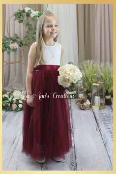 Burgundy Flower Girl Dress with Sunflower Sash Your little one's big moment deserves a dress that's just as special! Our Burgundy flower girl dress with tulle and lace is the perfect combination of sophistication and playfulness, complete with a beautiful sunflower sash. Discover how this dress can make her look and feel absolutely stunning on her special day! Ideal for that pretty flower girl dress, birthday party dress or special occasion. Dress Features A soft white bodice, made of stretchy l Maroon Flower Girl Dress, Burgundy Sunflower, Burgundy Flower Girl Dress, Dress Birthday Party, Dress With Tulle, Christmas Tops, Dress Birthday, Burgundy Flowers, Special Occasion Dress