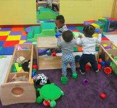 two children playing with toys in a play room