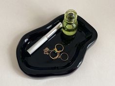 a black tray with a pen and scissors on it