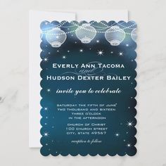 an elegant blue and white wedding card with lights on the top, in front of a marble