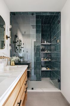 a bathroom with a walk in shower next to a sink