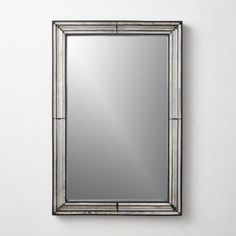 a large mirror hanging on the wall above it's reflection in a silver frame