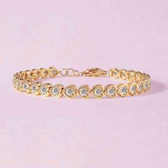 This bezel heart bracelet is a colorful and beautiful twist on a classic tennis bracelet! We love how this bracelet looks layered with other bangles and cuffs. 14k solid gold Average multi gemstone weight is 3.52cts Average pink sapphire weight is 3.0cts Average emerald weight is 2.47cts Heart dimensions: 5 x 4mm Length: 6" + 1" adjustable Yellow Gold Heart-shaped Cubic Zirconia Bracelets, Heart-shaped Yellow Gold Bracelets With Cubic Zirconia, Heart-shaped Yellow Gold Cubic Zirconia Bracelets, Luxury Cubic Zirconia Bracelet For Valentine's Day, Luxury Round Bracelets For Valentine's Day, Elegant Heart-shaped Tennis Bracelet For Valentine's Day, Rose Gold Heart-shaped Bracelet For Anniversary, Heart-shaped Tennis Bracelet For Anniversary, Cubic Zirconia Bangle Bracelet For Valentine's Day