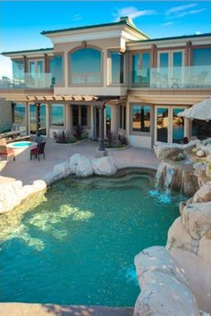 a large house with a pool in front of it