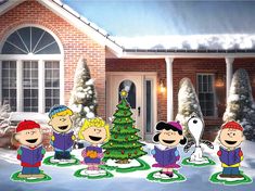 the peanuts gang standing in front of a christmas tree