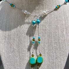 This colorful  design was handmade with genuine silk thread.  The lariat necklace is hand knotted with sparkling Austrian crystals, natural gemstone beads and Slovakian glass tabular beads.   Shimmery pearls add texture and light.  To wear the necklace, simply overlap the two ends.  No clasp required.  Easy to wear and adjust for your preference in length. Your jewelry design will be packaged in an attractive white gift box lined with anti-tarnish cotton. Thank you for looking today. Lisa Adjustable Green Beaded Lariat Necklace, Adjustable Turquoise Elegant Lariat Necklace, Colorful Beads Lariat Necklace Gift, Colorful Beads Lariat Necklace For Gift, Adjustable Lariat Necklace With Colorful Beads For Gift, Turquoise Beaded Dangle Lariat Necklace, Turquoise Lariat Necklace Gift, Turquoise Lariat Necklace As A Gift, Artisan Turquoise Lariat Necklace Adjustable