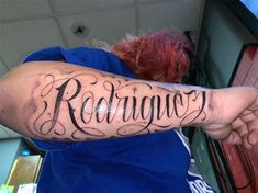 a man with a tattoo on his arm that says radwigy in cursive writing