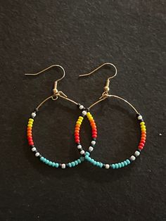 "Colorful Southwestern Style Glass Seed Bead Hoop Earrings  Yellow, orange, red, teal, black and white on. Gold hoop Nickel free Larger hoop is 1.5\" diameter  Smaller hoop is 1.25\" diameter  Both have a 2.25\" drop" Multicolor Hoop Earrings With Ear Wire, Adjustable Multicolor Bohemian Hoop Earrings, Multicolor Bohemian Hoop Earrings, Orange Hoop Earrings With Colorful Beads, Multicolor Hoop Earrings With Round Beads, Orange Nickel-free Bohemian Hoop Earrings, Orange Small Hoop Earrings With Ear Wire, Orange Bohemian Nickel-free Hoop Earrings, Southwestern Multicolor Nickel-free Beaded Earrings