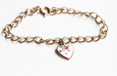 This is a nice vintage bracelet from about the 70s. It's the perfect bracelet to throw on with anything.It fits a small/medium wrist and measures 7" around. It has an antiqued look to it. The chain is plated brass and the charm is enamel.--Shop Policies--Please be sure to read our shop policies before making your purchase. Thank you!https://www.etsy.com/shop/diamentdesigns/policy Bracelet Flower, Bracelet Heart, Vintage Bracelet, Enamel Bracelet, Bracelet Charm, Flower Bracelet, The 70s, Vintage Bracelets, Flower Heart