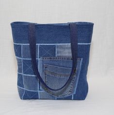 a denim tote bag with an open pocket