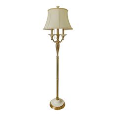 a floor lamp with a white shade on the top and gold trimmings around it